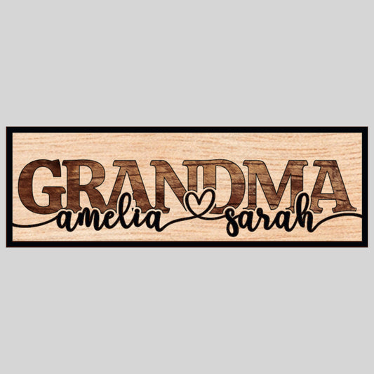A custom laser-cut wooden sign with the word 'GRANDMA' in bold letters and two names, 'amelia' and 'sarah', personalized on the sign's surface.
