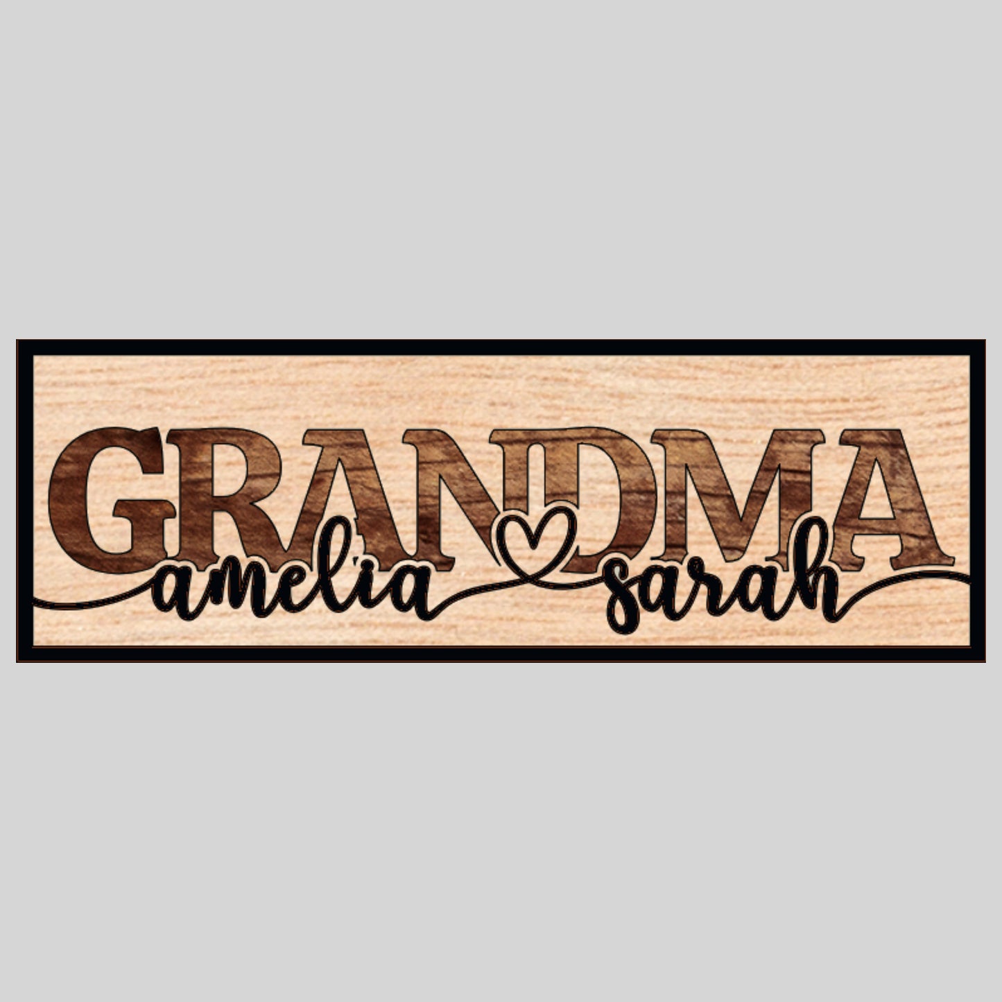 A custom laser-cut wooden sign with the word 'GRANDMA' in bold letters and two names, 'amelia' and 'sarah', personalized on the sign's surface.