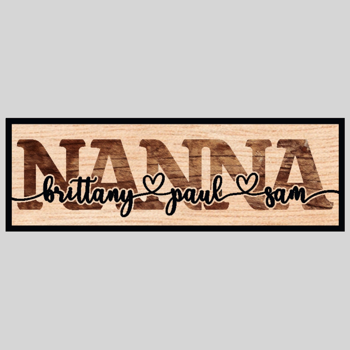 A custom laser-cut wooden sign with the word 'GRANDMA' in bold letters and two names, 'amelia' and 'sarah', personalized on the sign's surface.